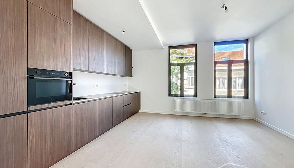 Dit charmante vernieuwde appartement in een klein gebouw,  biedt een perfecte balans tussen comfort en stijl, gelegen in de levendige en vernieuwende wijk Stuivenberg. 
Bij binnenkomst inkomhal met een apart toilet. De lichtrijke leefruimte van ca. 29m² 
