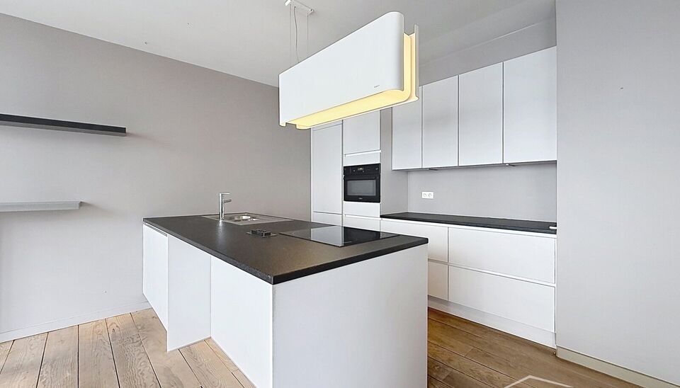 Ruim appartement (ca. 105m&sup2;) gelegen op de 1e verdieping van residentie Chacalli, op wandelafstand van het bruisende Eilandje. Via de inkomhal met ingemaakte kast en apart gastentoilet bereikt u de ruime en lichtrijke leefruimte (ca. 39 m&sup2;), afgewerkt m
