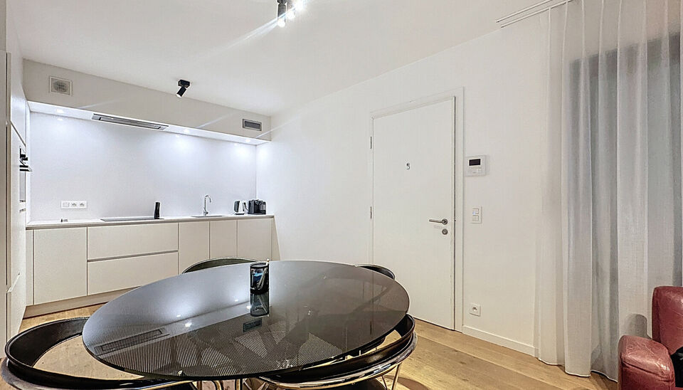 Dit stijlvol afgewerkt studioappartement op de eerste verdieping combineert comfort, licht en een topligging op een boogscheut van het MAS en het bruisende Eilandje. 
De leefruimte met open keuken (32 m&sup2;) is volledig voorzien van hoogwaardige parketvloer
